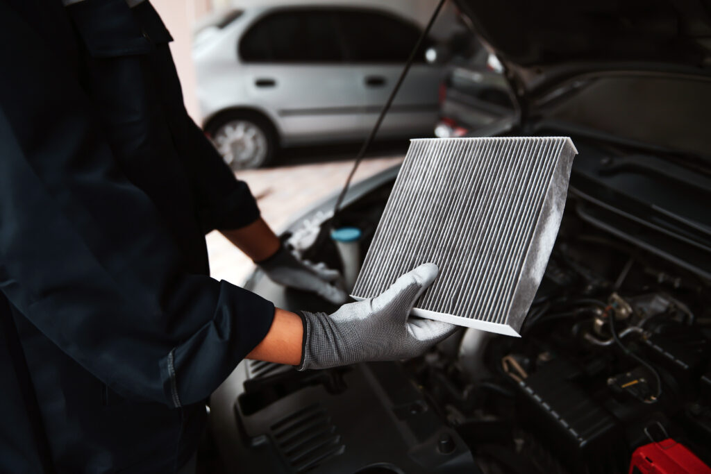 Car air conditioner system maintenance, Hand mechanic holding car air filter to check for clean dirty or fix repair heat have a problem or replace new or change filter.